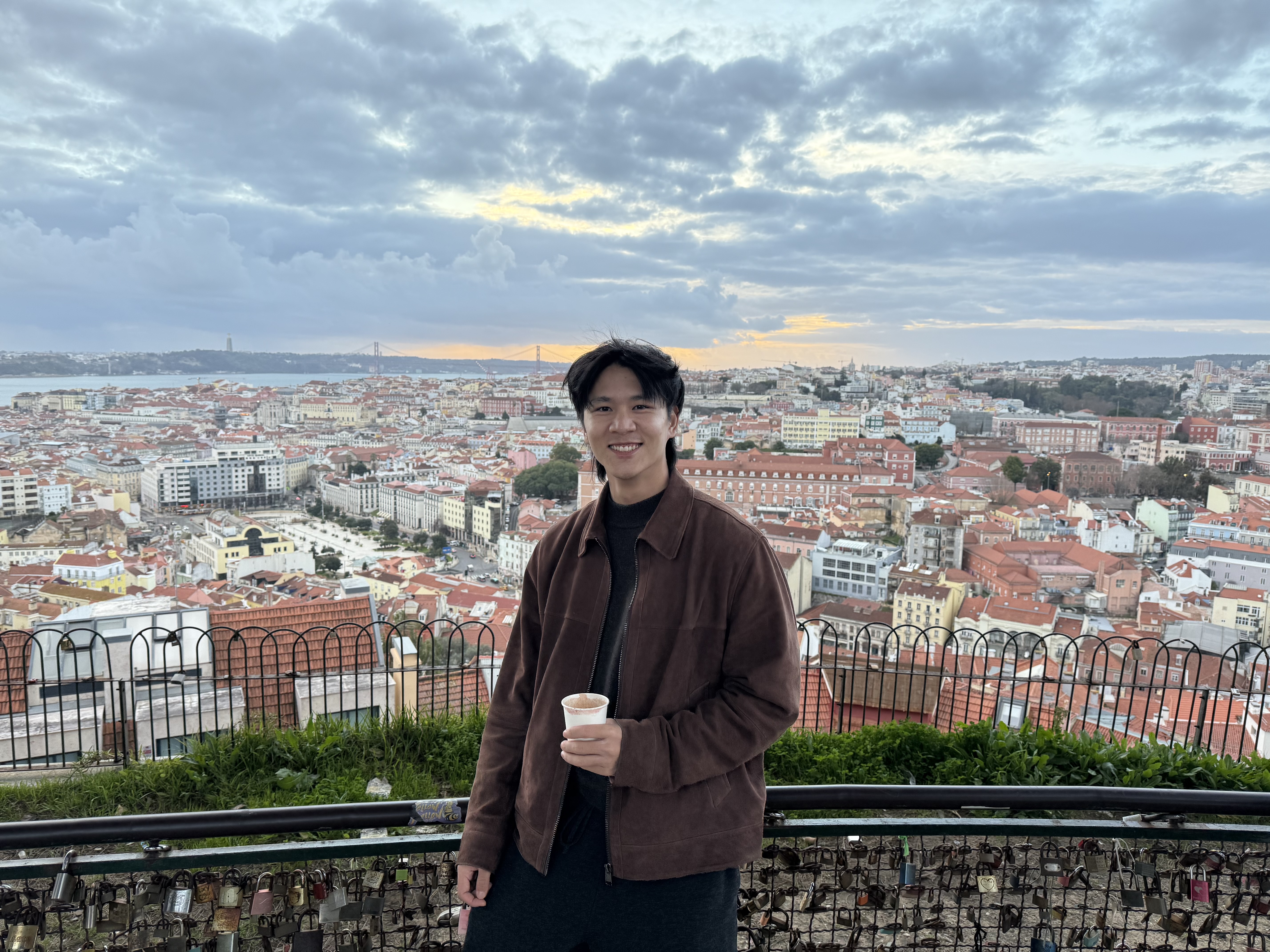 Person standing outdoors in warm golden hour light with nature in the background